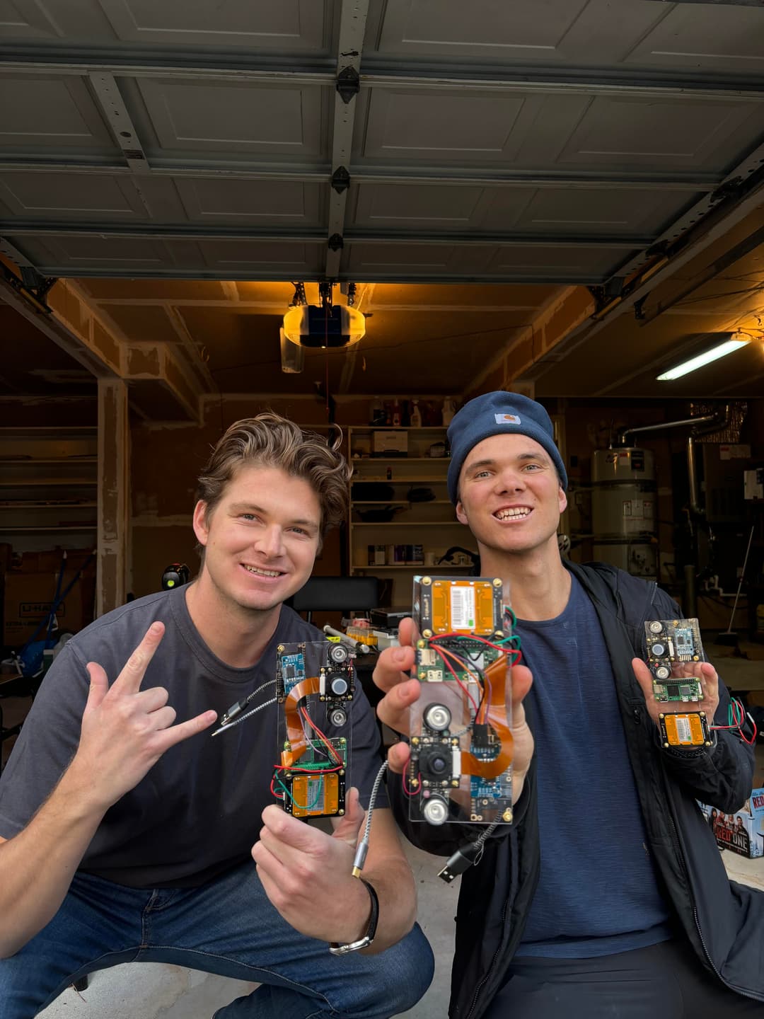 Two people holding up circuit boards