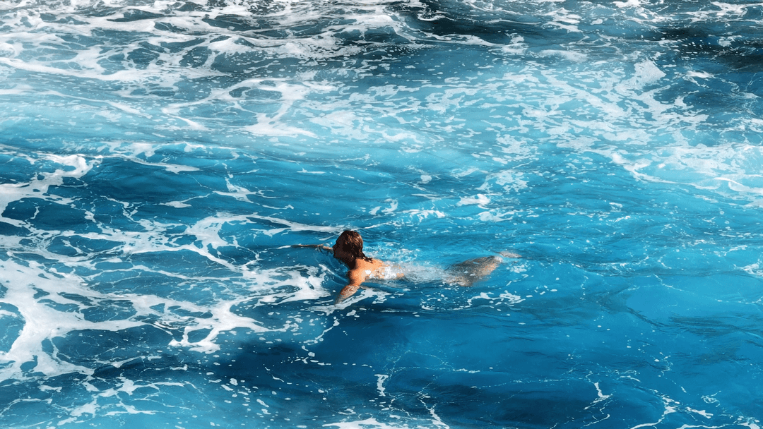 Person swimming in ocean